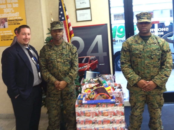 Jason Schroeck, Social Media & Web Manager pictured here with U.S. Marines Sergeant Ceasar and Corporal Hamilton when they picked up our Toys for Tots boxes today.  — at Toyota of Manhattan.